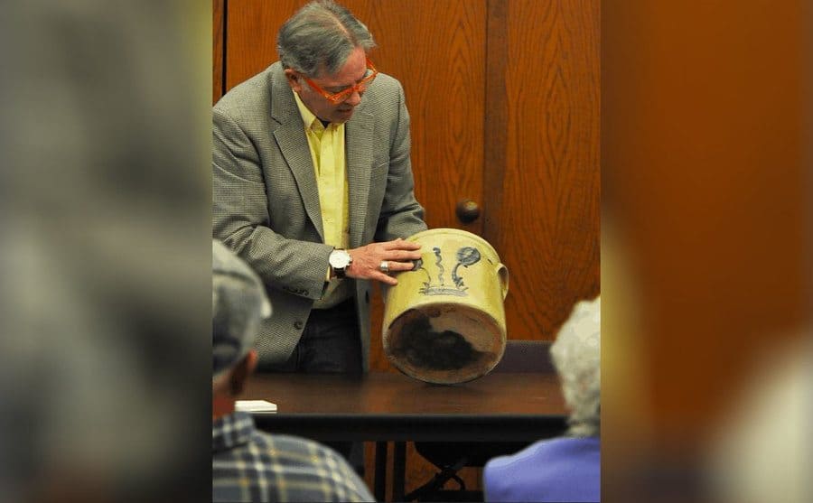 A photograph of Jeff holding a ceramic pot 