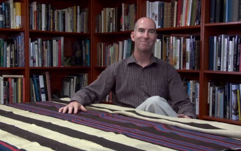 Jeff looking very happy next to the blanket 