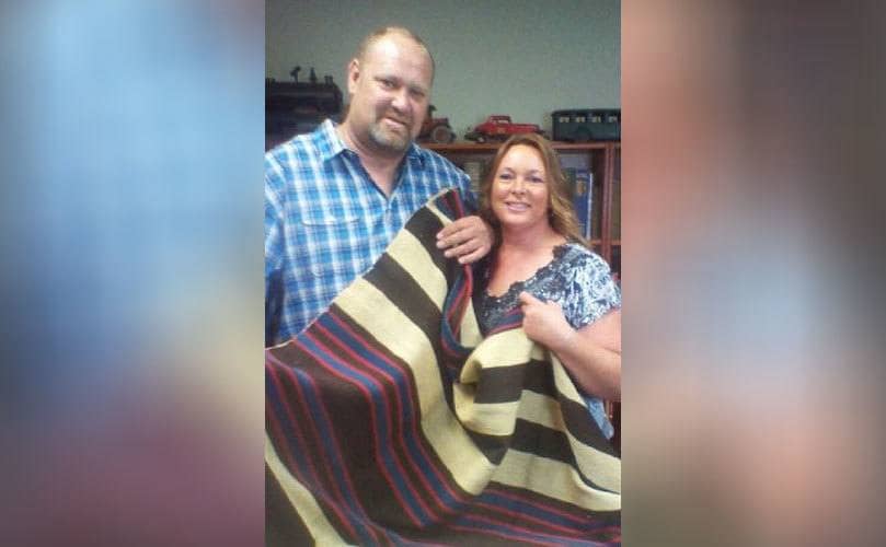 Loren and his wife holding the blanket 