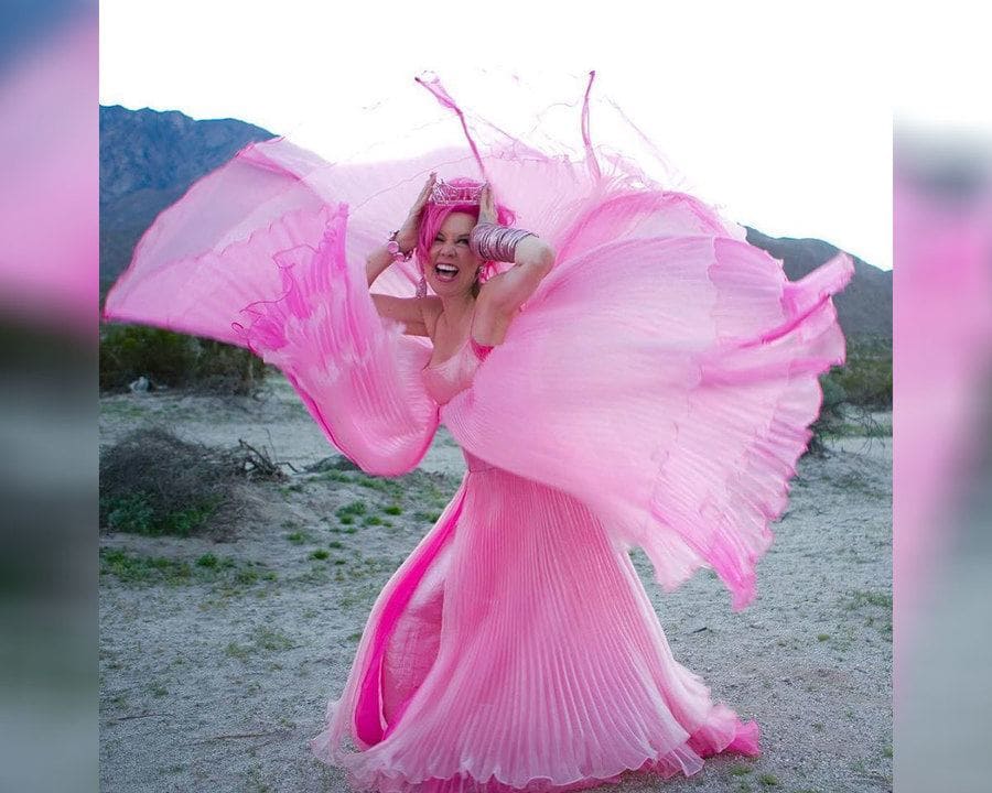 Kitten Kay Sera in a flowing pink dress which is up around her 