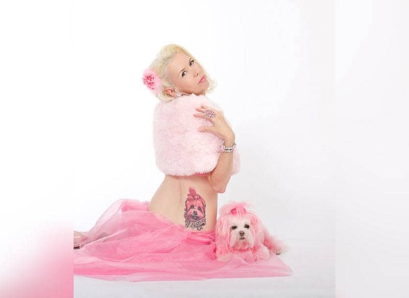 Kitten Kay Sera with her pink dog tattoo showing while she sat next to Miss Kisses 