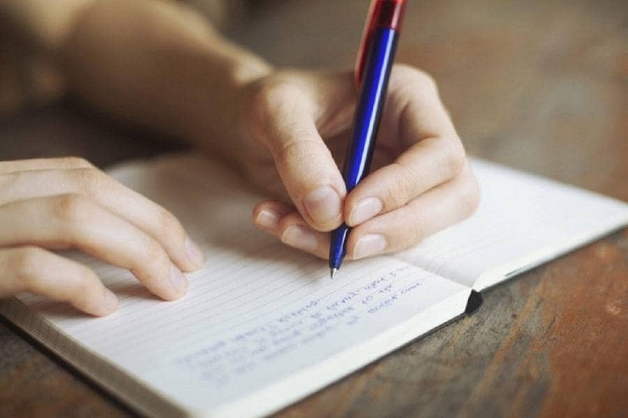 Women writing in a notebook
