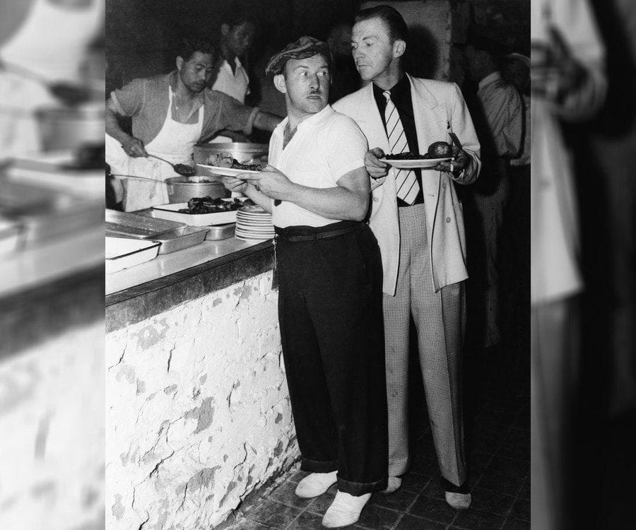 Men standing in the food line 