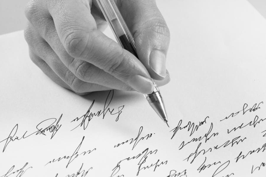 A woman writing a handwritten letter 
