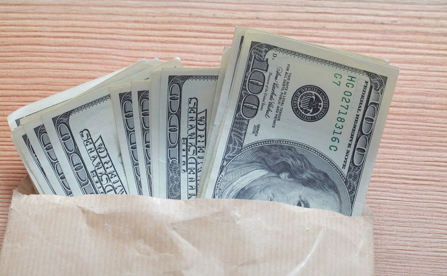 An envelope filled with hundred-dollar bills