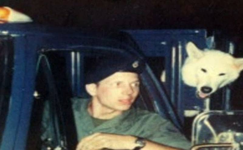 Marty drives a military truck with his dog in the back