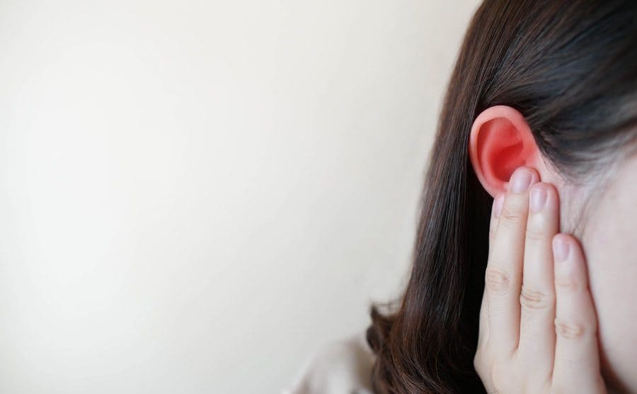 A girl holding her ear