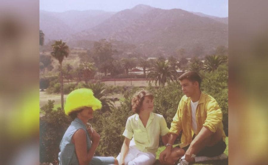 Janice, Prentiss, and her mother on a rock near the beach 