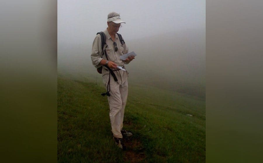 Prentiss walking through a cloudy field 
