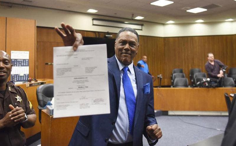 Richard Phillips holding up his papers after being exonerated