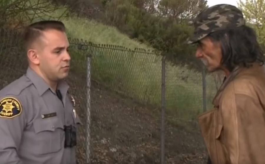 Deputy Sheriff Jacob Swalwell and Mick standing on the side of the road