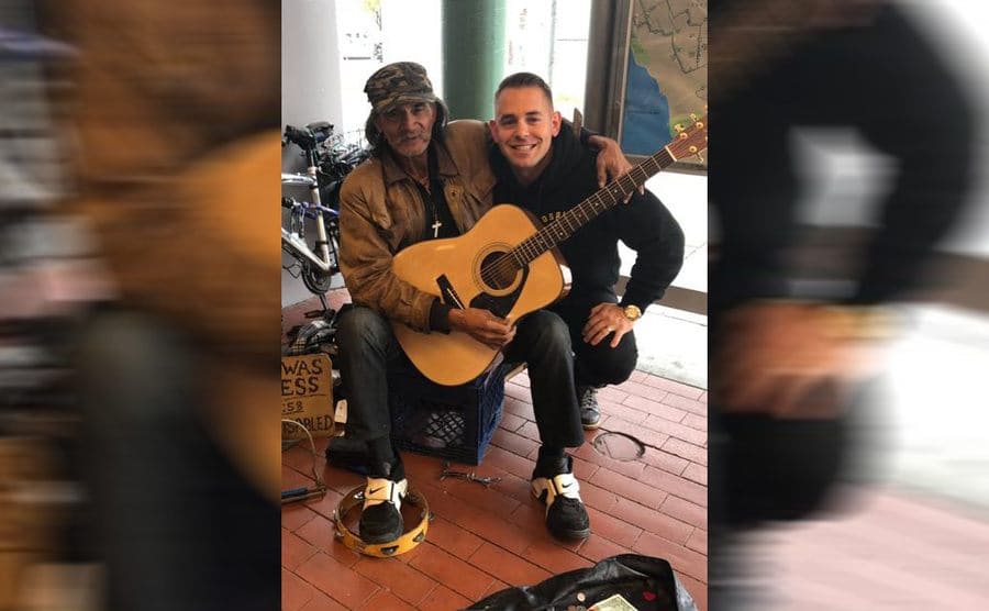 Mick and the Deputy posing with a guitar