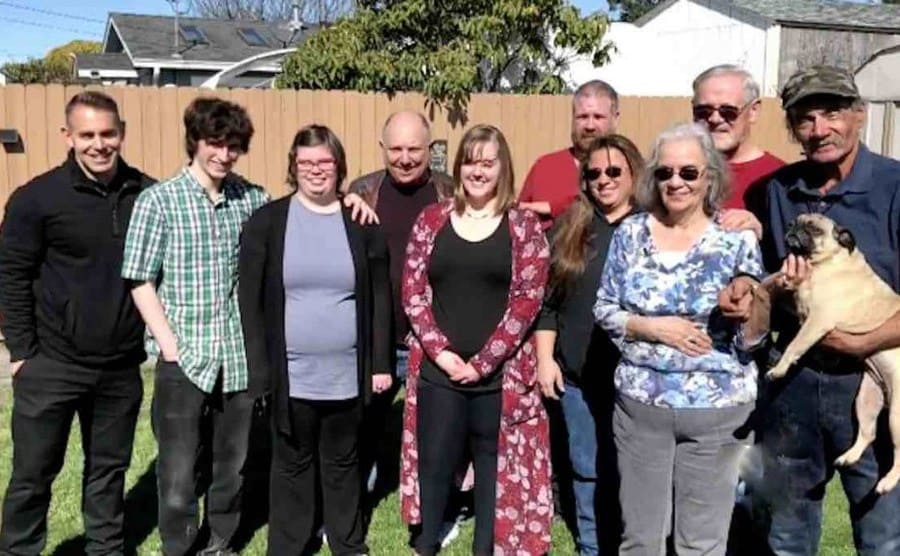 Mick and his whole family posing in the backyard