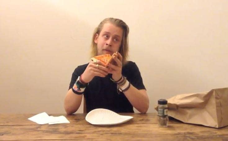 Macaulay Culkin in the video tribute to Andy Warhol eating pizza
