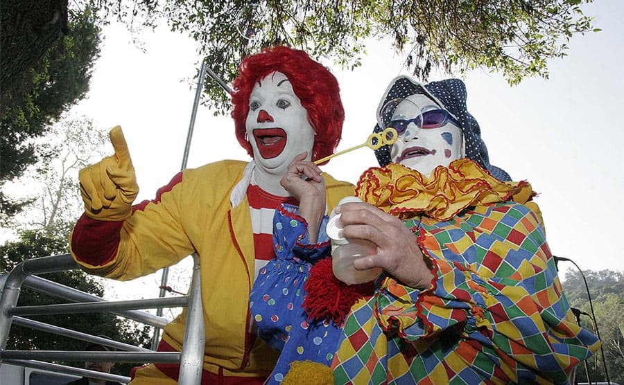 Ronald McDonald with a clown blowing bubbles