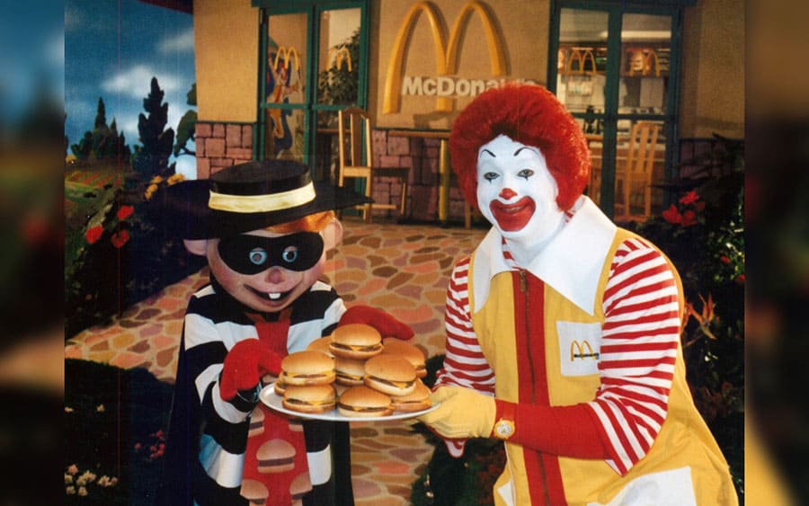 Ronald McDonald eating a burger in a commercial from the 80s