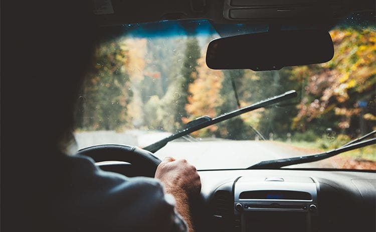 A view out of the front window of a car while someone drives