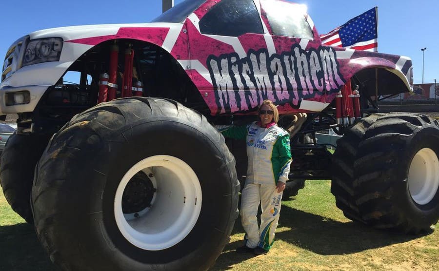 Kim Crosby next to a monster truck 