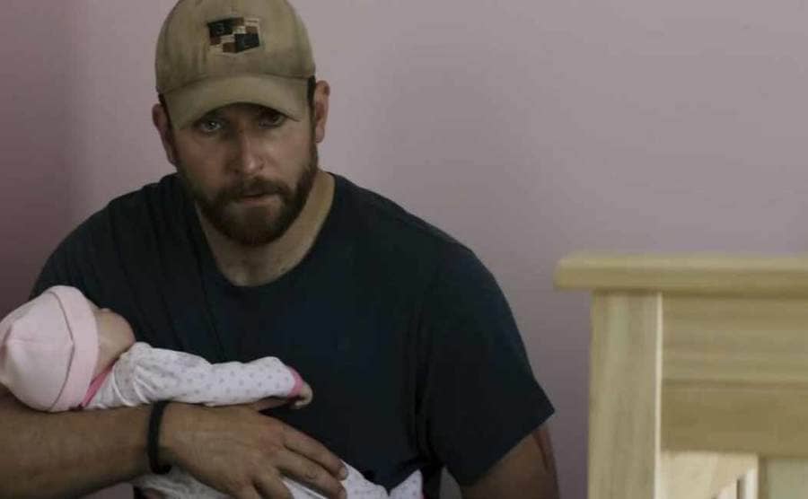 Bradley Cooper holding a fake baby in the film American Sniper
