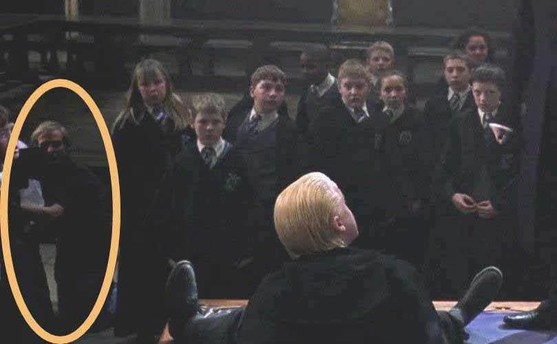 Malfoy on the ground in a scene from Harry Potter and the Chamber of Secrets with the camera man in the background