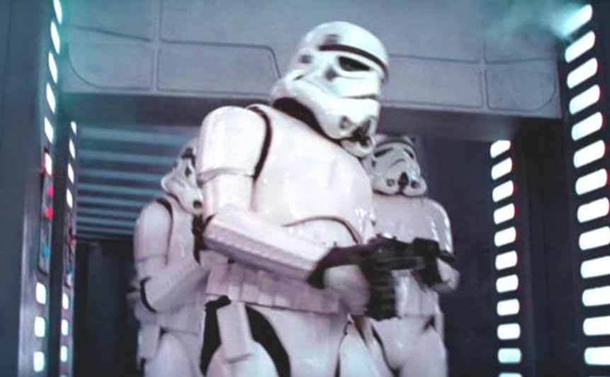 The Stormtroopers walking through a doorway with one of them running into the top of the door frame