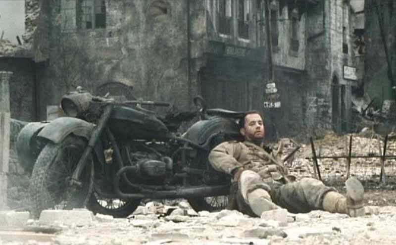 Tom Hanks leaning on a motorcycle in the film Saving Private Ryan