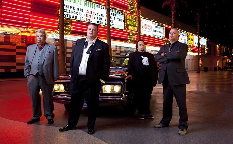 Richard, Corey, Chumlee, and Rick Harrison in front of a nice old car