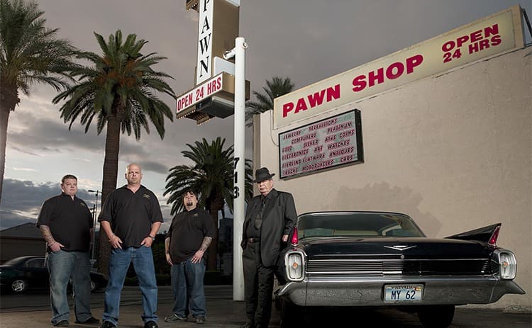 Corey Harrison, Rick Harrison, Chumlee Harrison, and Richard Harrison posing in front of their pawnshop