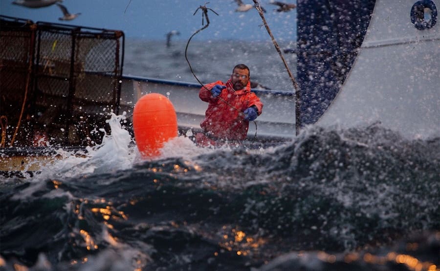 A man fishing during a large storm on the Deadliest Catch
