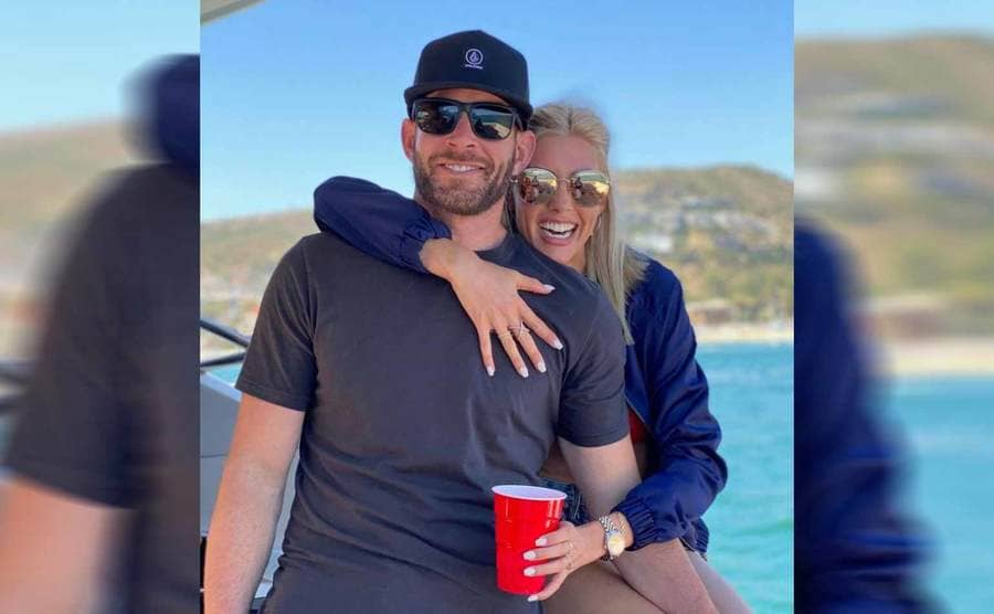 Tarek El Moussa and Heather Rae Young posing together on a yacht