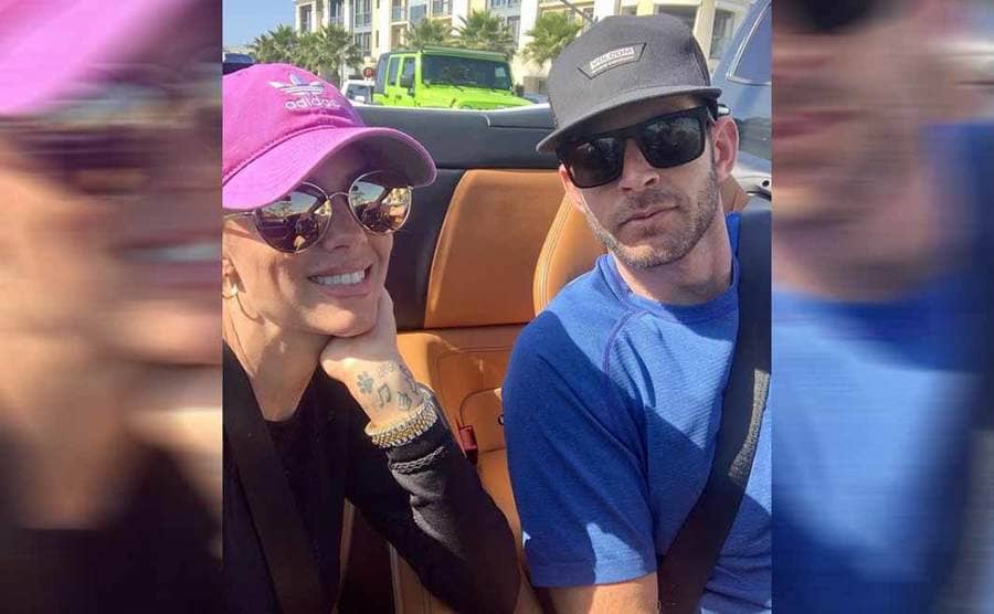 Heather and Tark posing together in their car