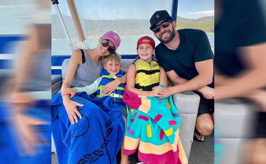 Heather and Tarek with his children on a boat