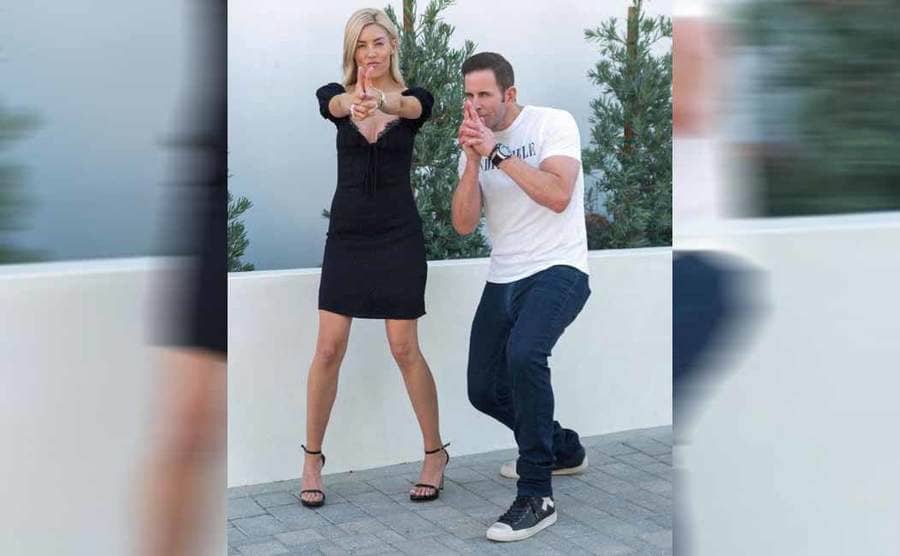 Heather and Tarek posing with their fingers shaped liked guns