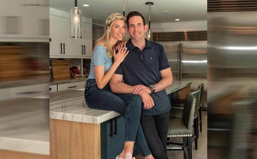Heather and Tarek posing together in a kitchen