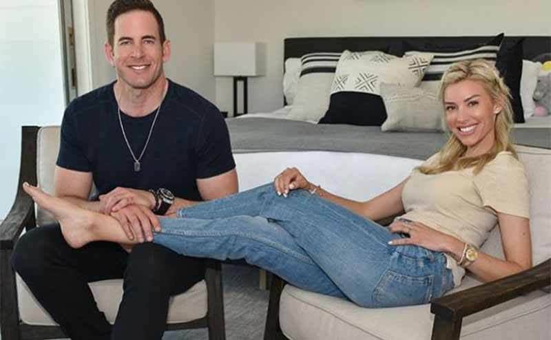 Tarek and Heather posing together in a bedroom