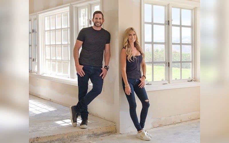 Tarek and Christina posing in a partially renovated house