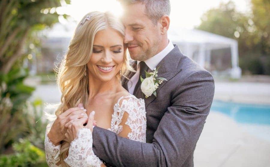 Anthony holding Christina for a wedding photo