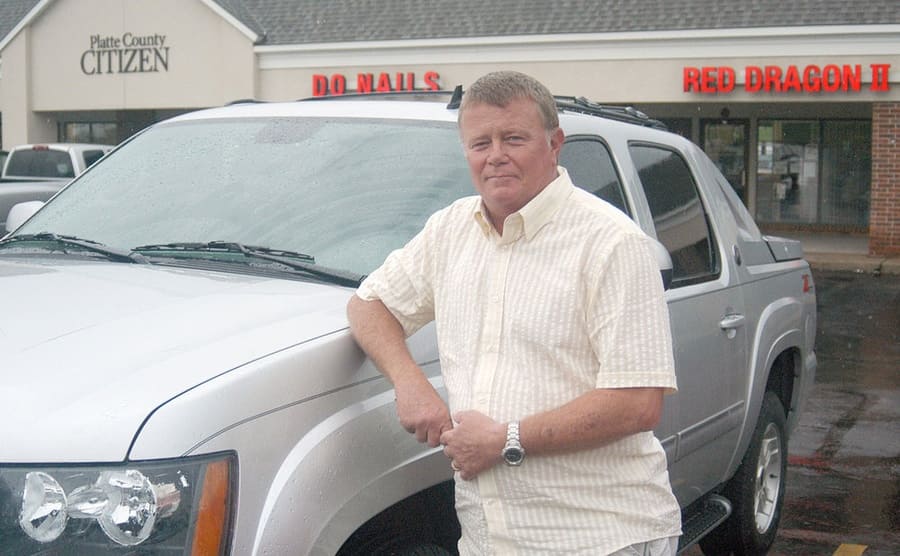 Mark Hill posing in front of his truck