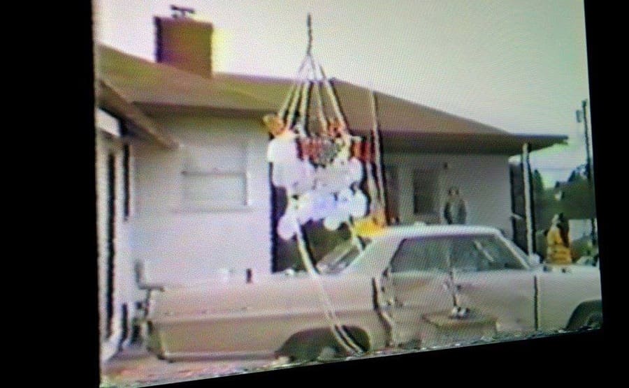 The lawn chair floating above Larry’s car outside of his house