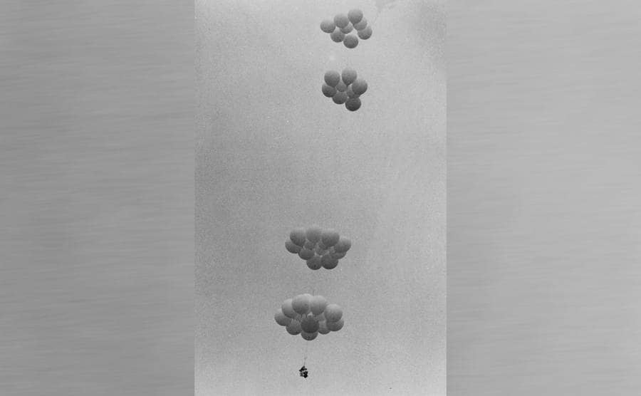Lawn Chair Larry floating where you can only make out the balloons and a small black dot where Larry is sitting