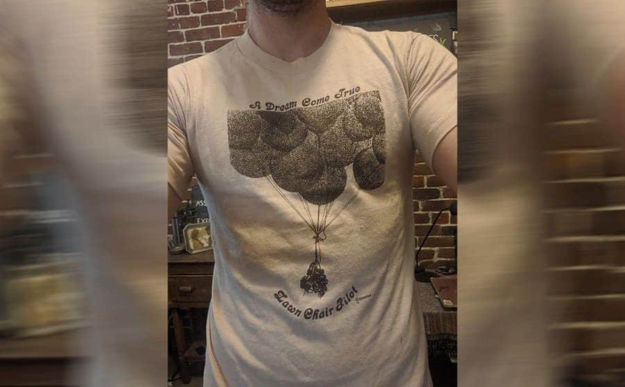 A documentary crew member wearing an original Lawn Chair Pilot t-shirt