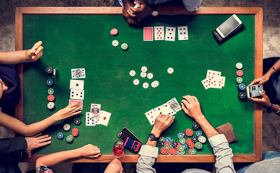 An aerial view of people playing a card game in the casino