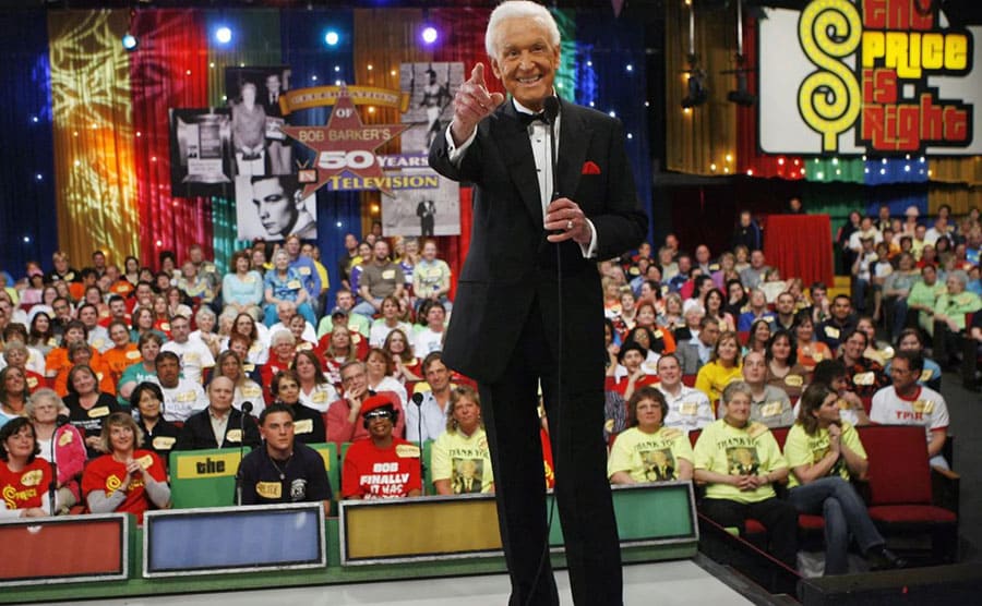 Bob Barker pointing to the camera with a large audience behind him