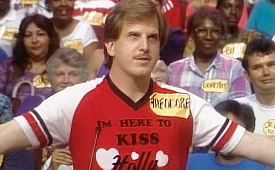 Ted standing behind the podiums with his arms spread