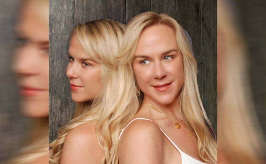 Alexandria and Anastasia Duval posing back to back