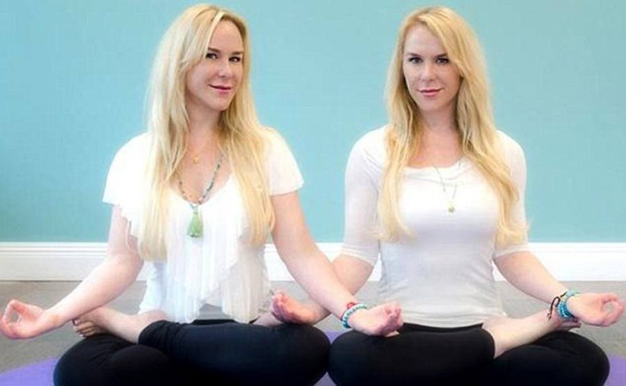 Alexandria and Anastasia Duval doing a yoga pose together