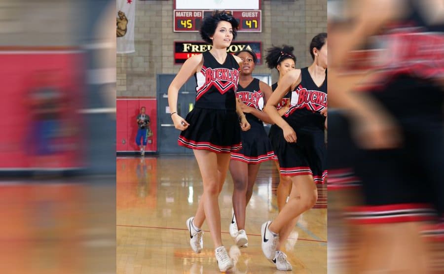 Paris Jackson in her cheerleading uniform / Paris Jackson posing with another team member in uniform