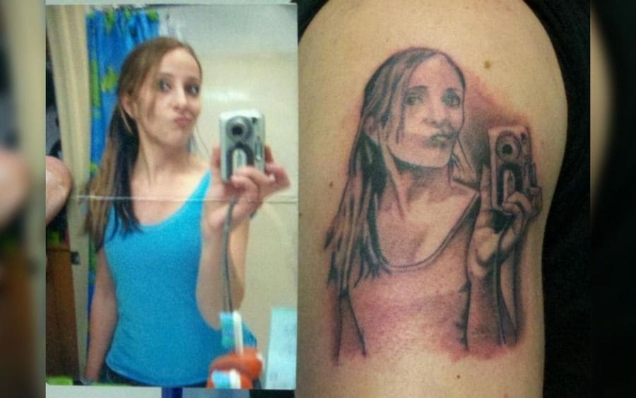 A tattoo of a girl holding a camera for a selfie