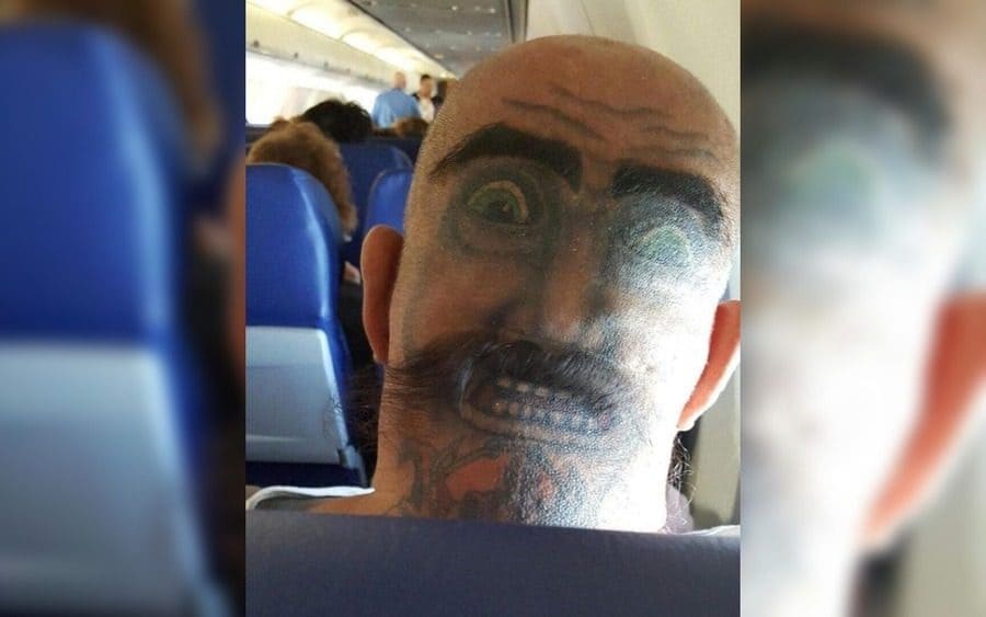 A tattoo of a face on the back of someone's head