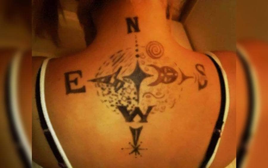 A tattoo of a compass drown the wrong way